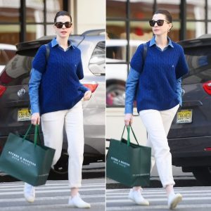 Anne Hathaway rocks preppy style in royal blue sweater and khaki trousers while shopping in NYC.